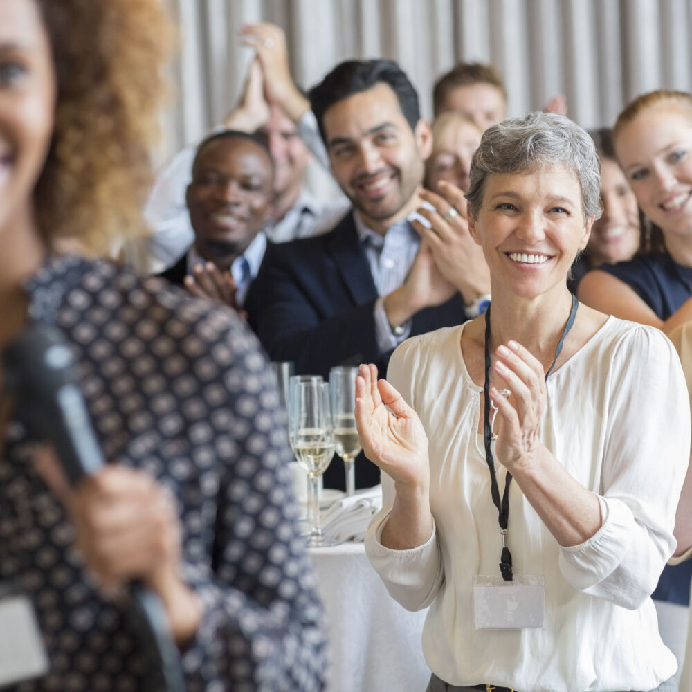 Group of people applauding after speech during conference